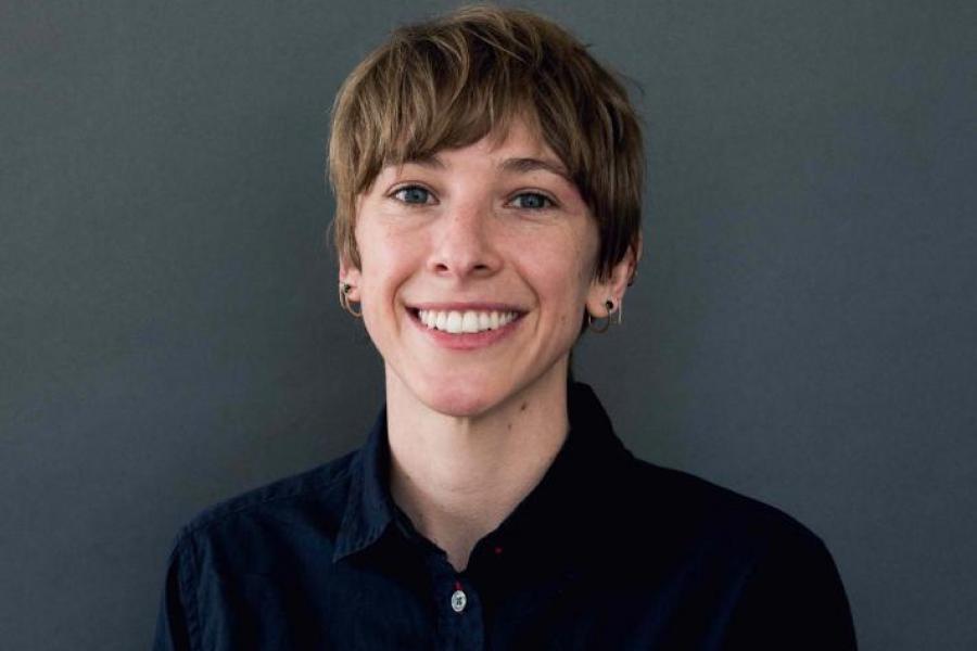 Natalie Wolchover wearing a blck shirt and earrings