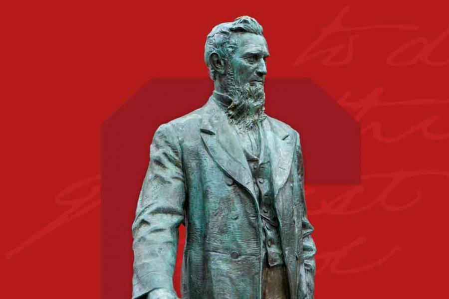statue of Ezra Cornell against red background