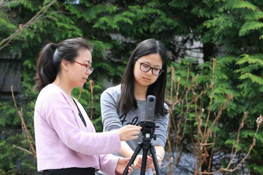 two students with video camera