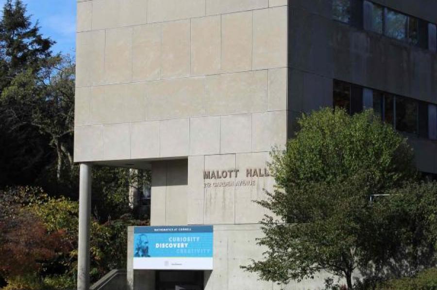 Malott Hall with a banner saying "curiosity, discovery, creativity" in front of it.