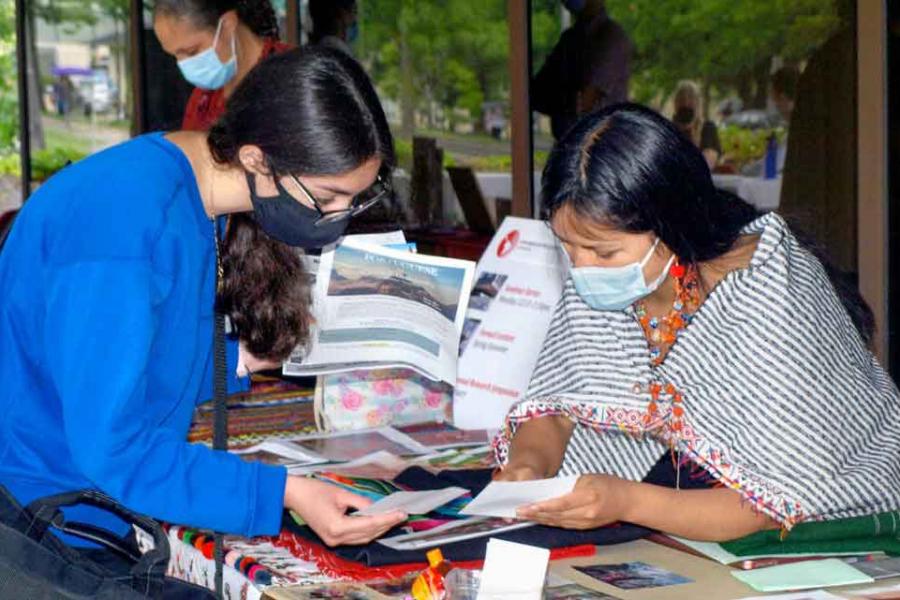 two women looking at papers