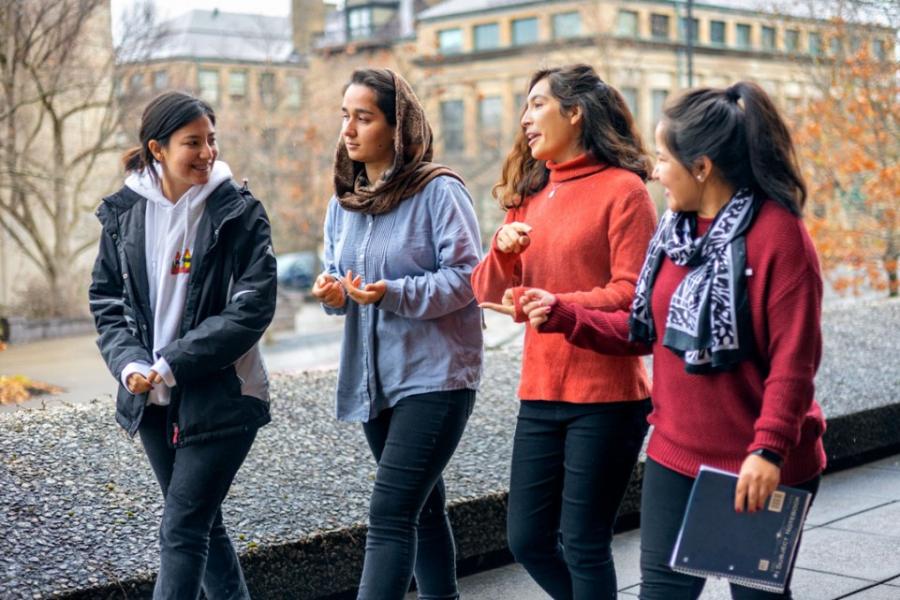 Four people walk along together