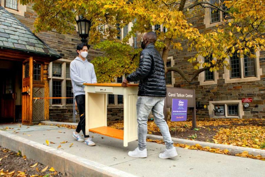 students moving furniture