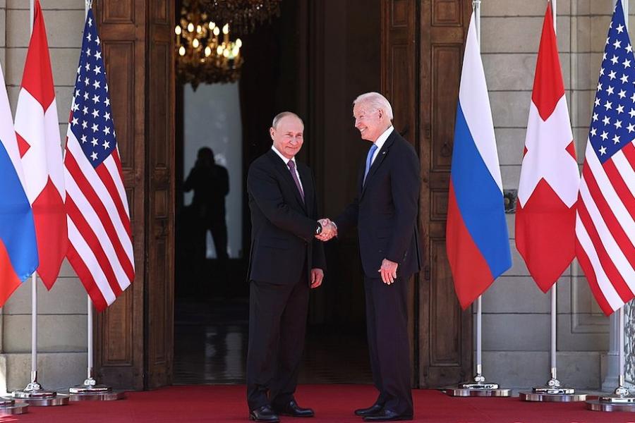 Two people in suits shake hands