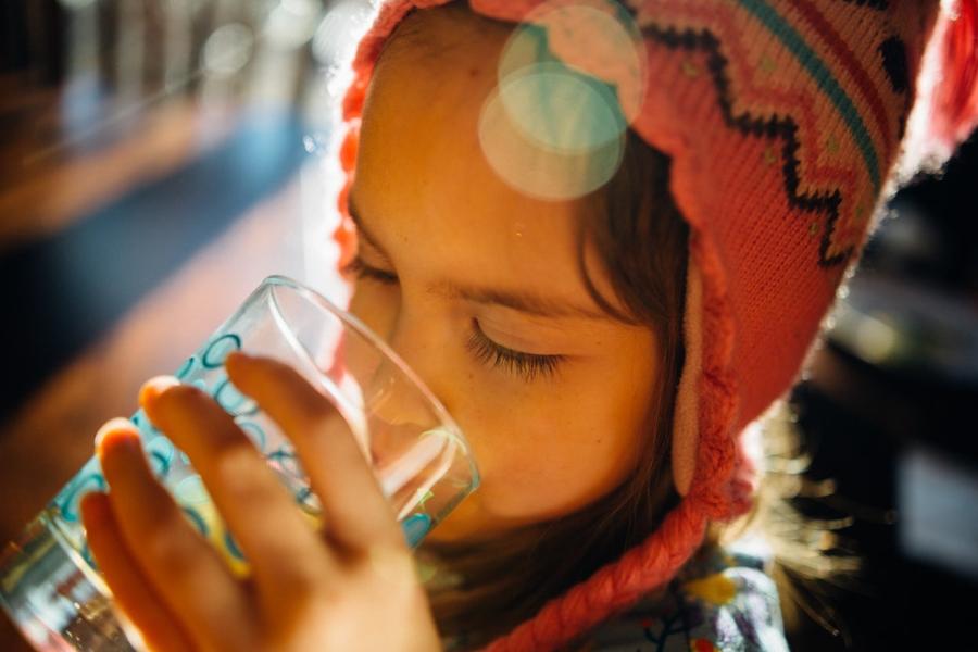 Child drinking water from a glass