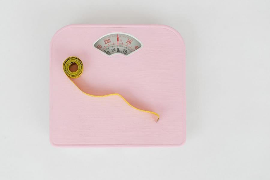 Pink bathroom scale and measuring tape