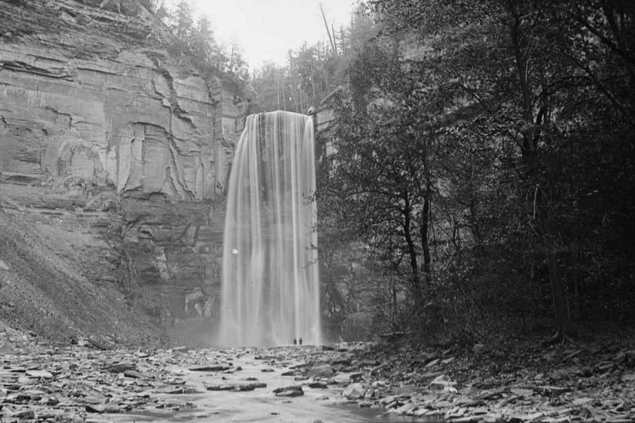 Historical black and white photo of a large waterfall