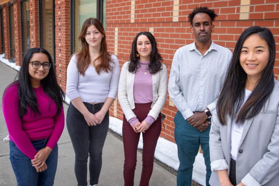 Five people facing the viewer