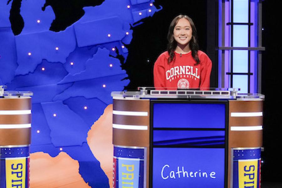 Three people on a game show set