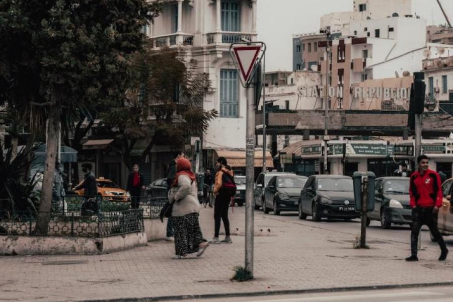 Busy street, white stone buildings, hazy sky