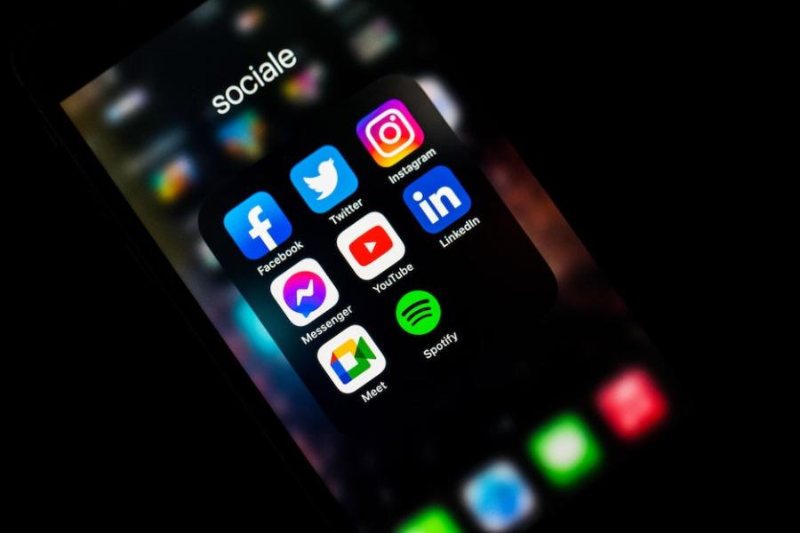 Social media icons glow on a smart phone