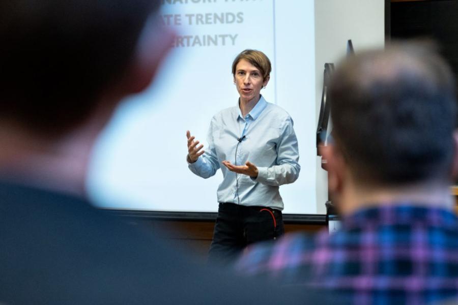 Person speaking at the front of a room