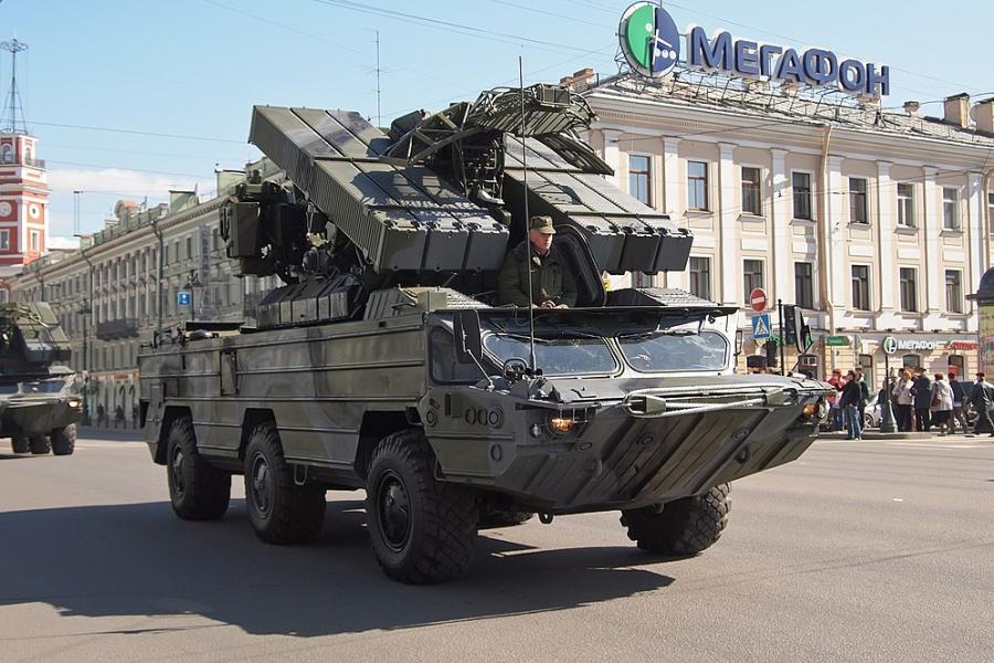 Russian army tank driving on a city street
