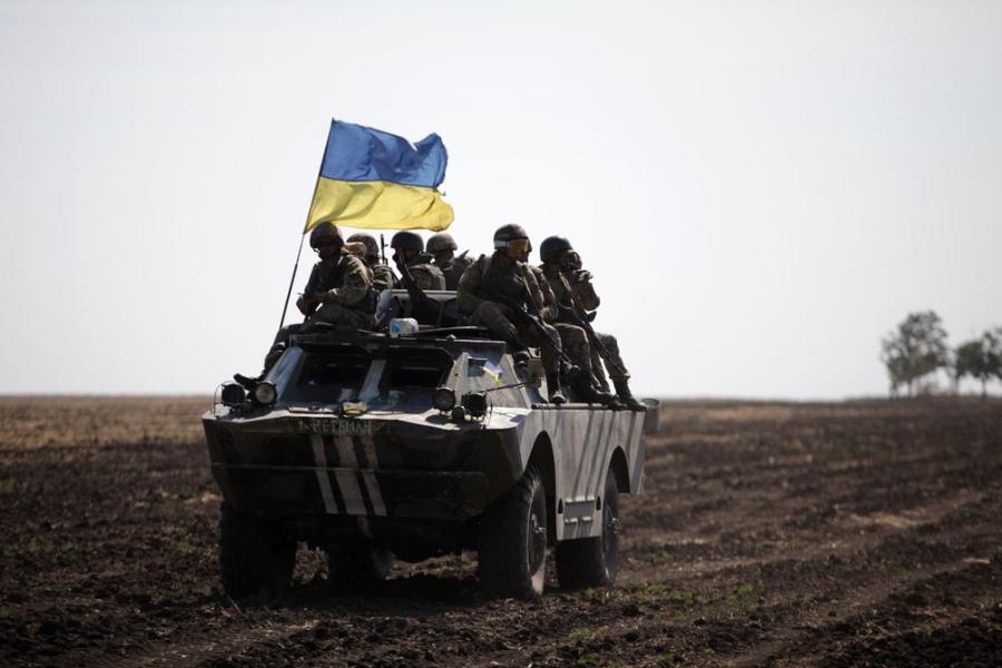 armored vehicle flying a blue and yellow flage