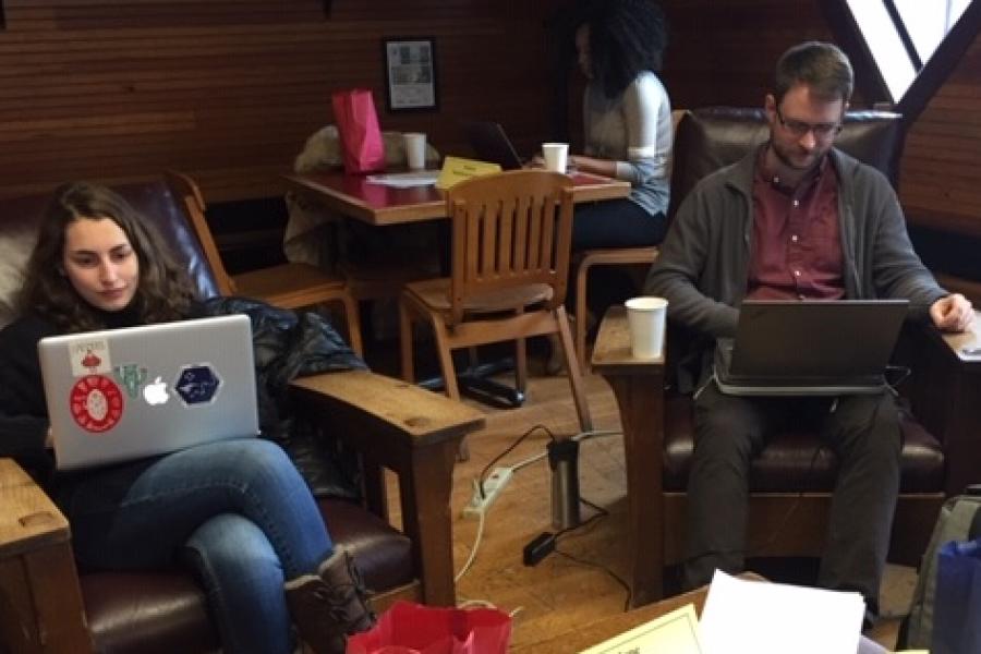 People work on laptop computers in a cozy room