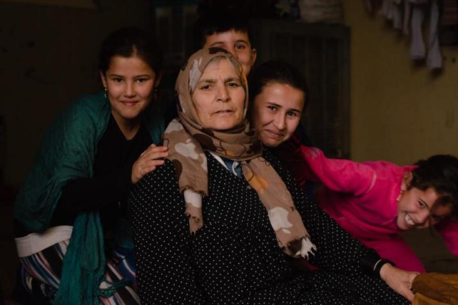 Adult surrounded by four laughing children