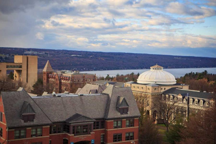 Campus buildings, cloudy sky, lake