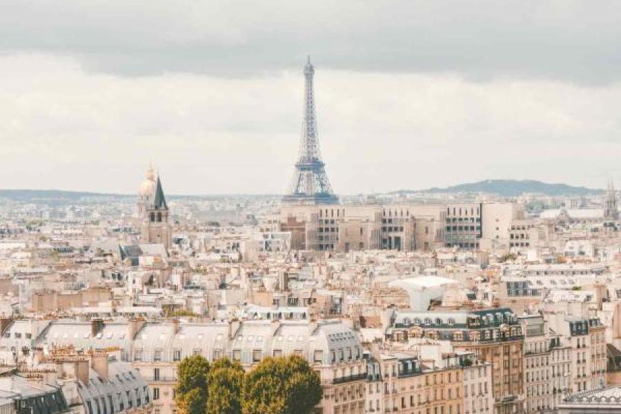 A view of Paris, showing the Seine, buildings and the Eiffel Tower in the distance.