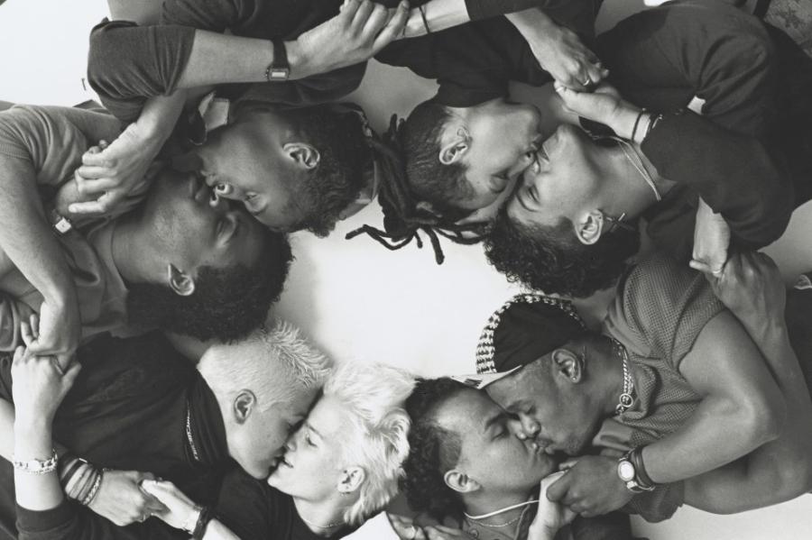 Eight people arranged in a circle; an artistic black and white photo