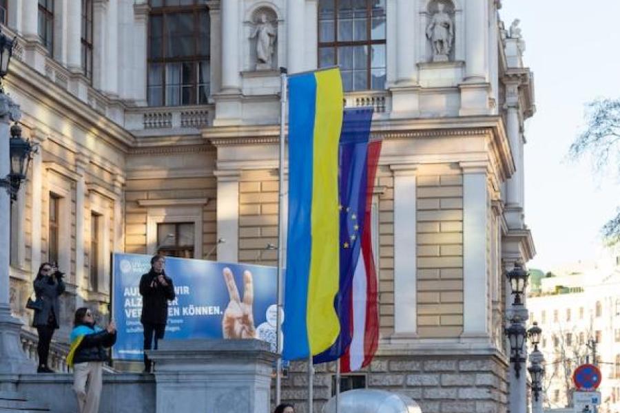 Banners flying outside a stately building