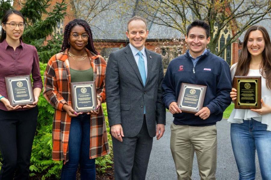 Five people facing the camera, smiling 