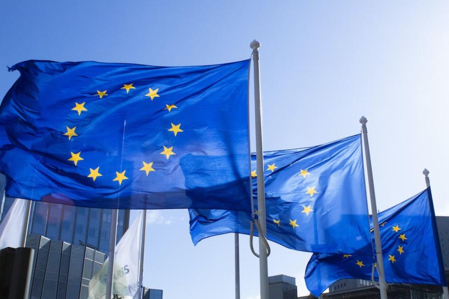 Three blue flags on poles