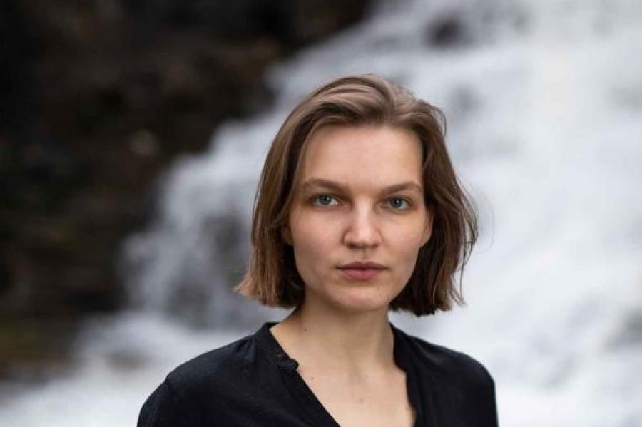 woman in front of waterfall