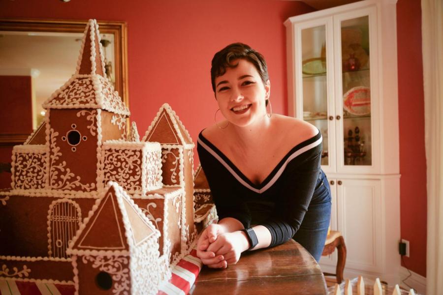 girl by gingerbread house