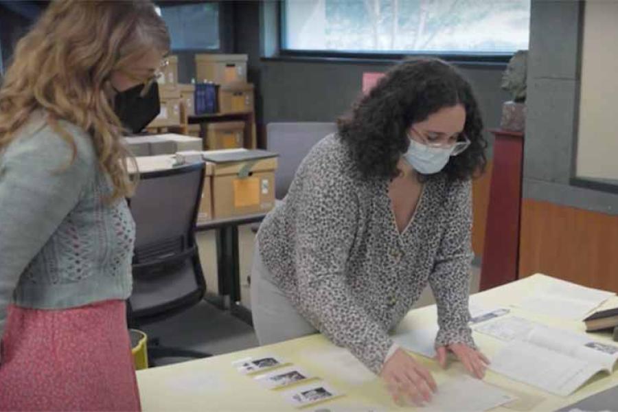 Two people working with pieces of paper