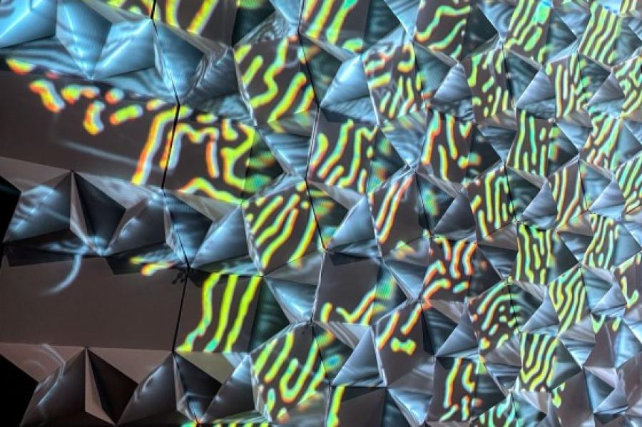 geometric pattern featuring triangles of shimmery green and blue