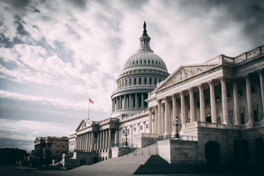 A stately government building under a partly cloudy sky