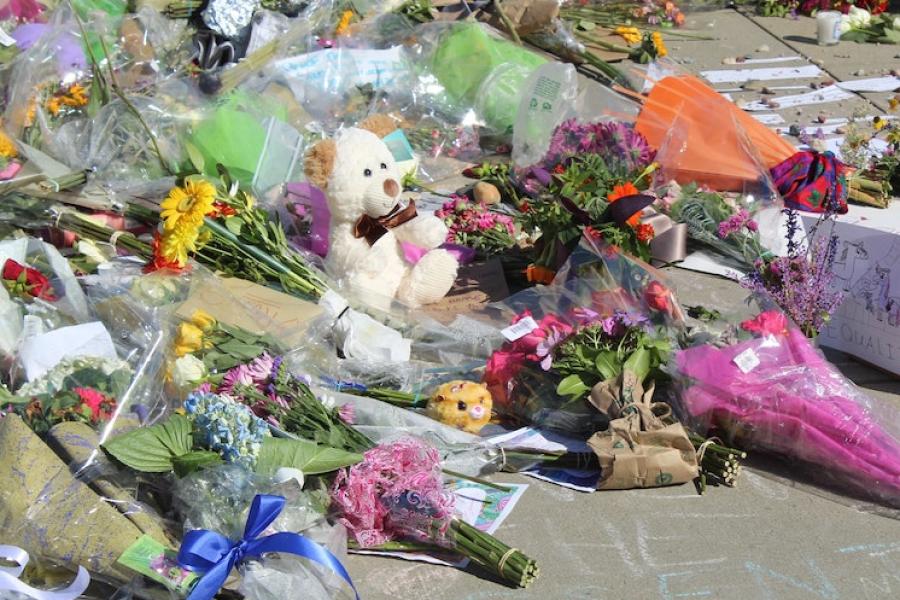 Bouquets at a sidewalk memorial