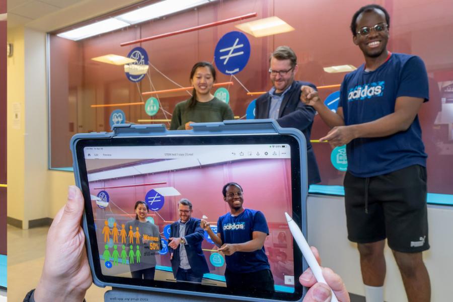 Three people appear on a screen