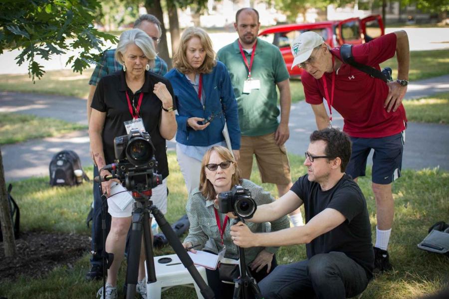 people watching someone with a video camera