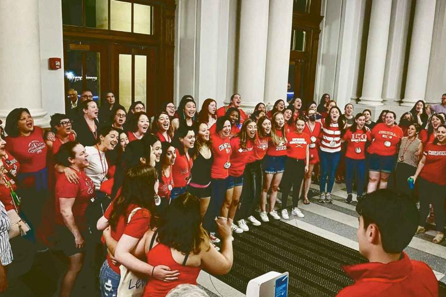 people singing in Goldwin Smith Hall