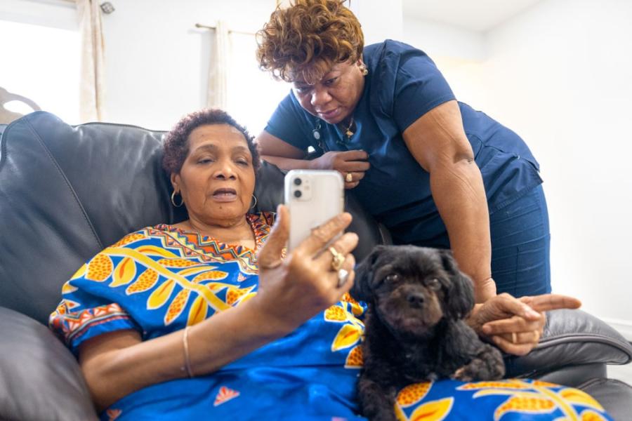 woman looking at another woman's phone
