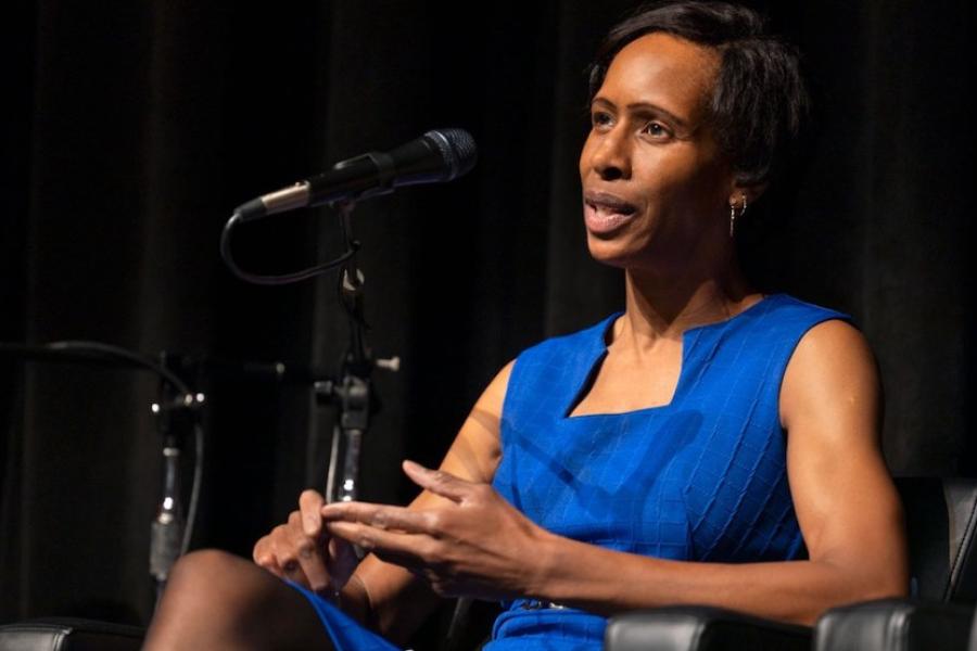 Person speaking authoritatively from a stage