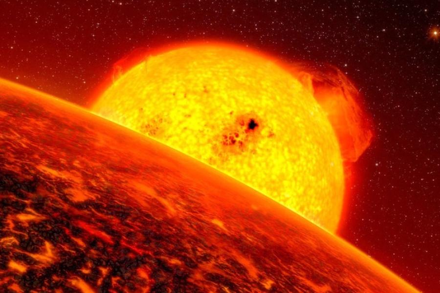 Blazing yellow celestial body seen beyond the horizon of another globe, tinted red