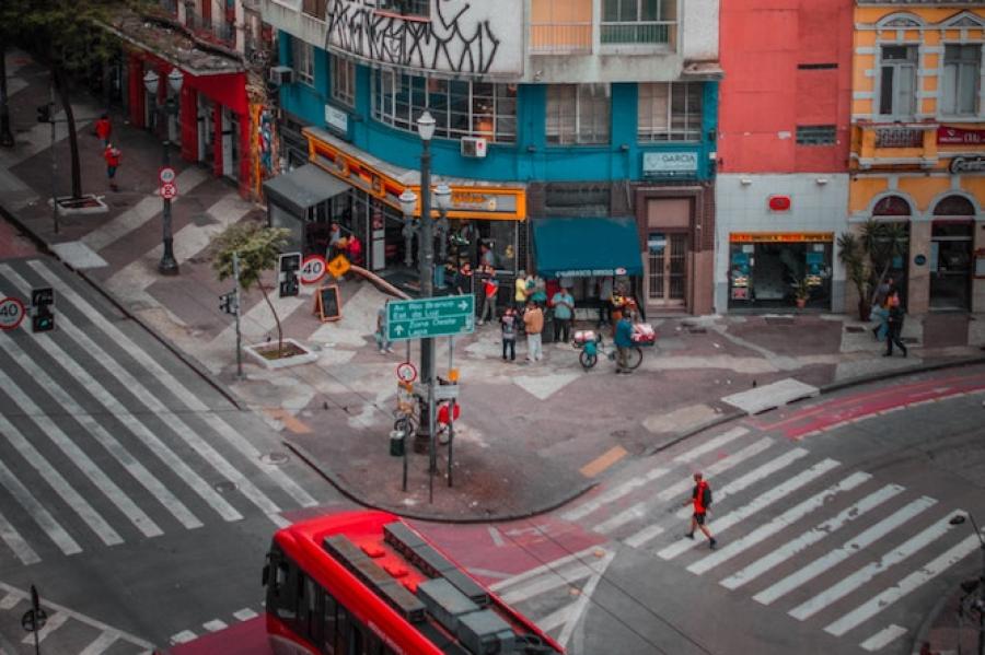 White apartment building towers over a street corner