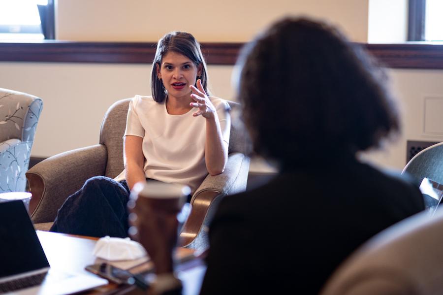 Person sitting in a chair, speaking dynamically