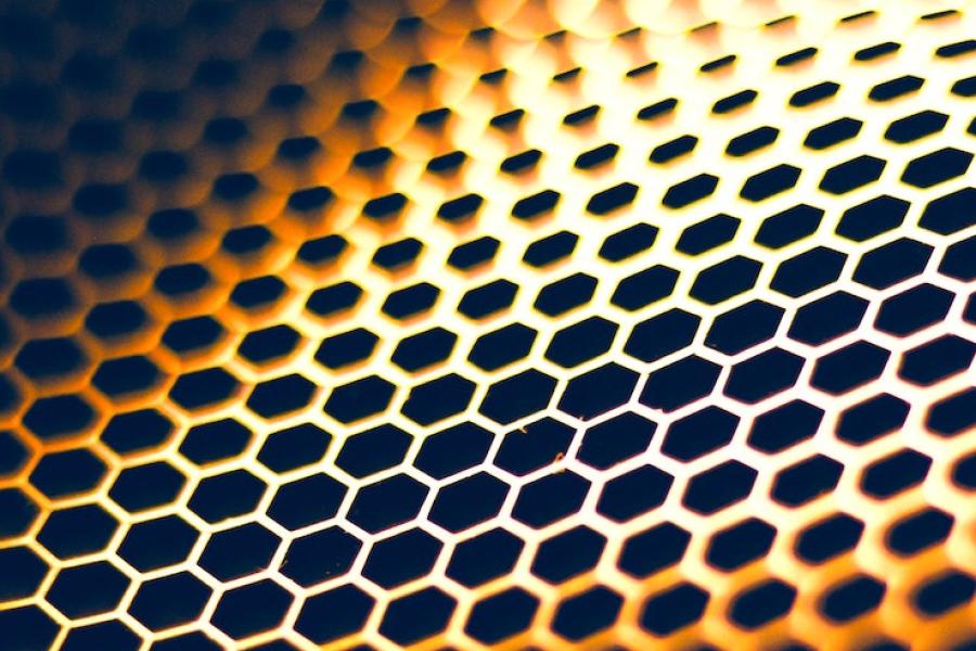 Pattern of six-sided shapes in oranges, yellows and black