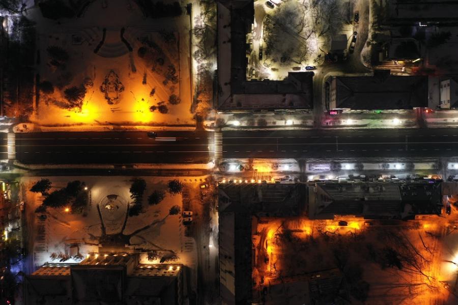 City blocks lit up at night, seen from far above