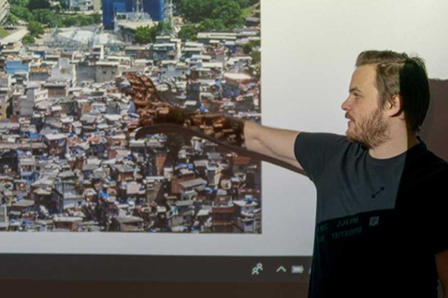 Person gesturing at a projection on a wall