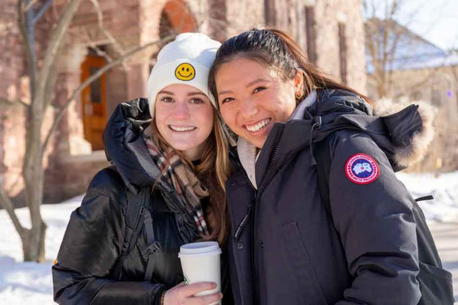 two women students outside in the snow
