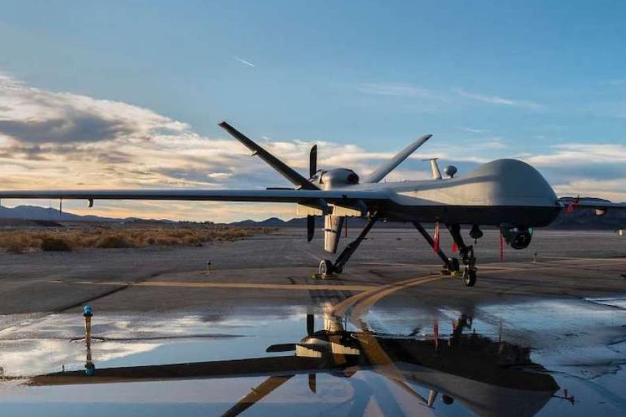 Large aircraft without a cockpit parked on a runway at sunset