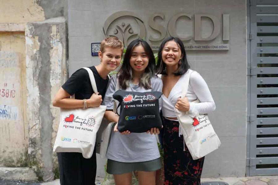 three women with tote bags