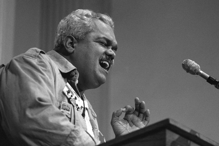 Person speaking passionately into a microphone