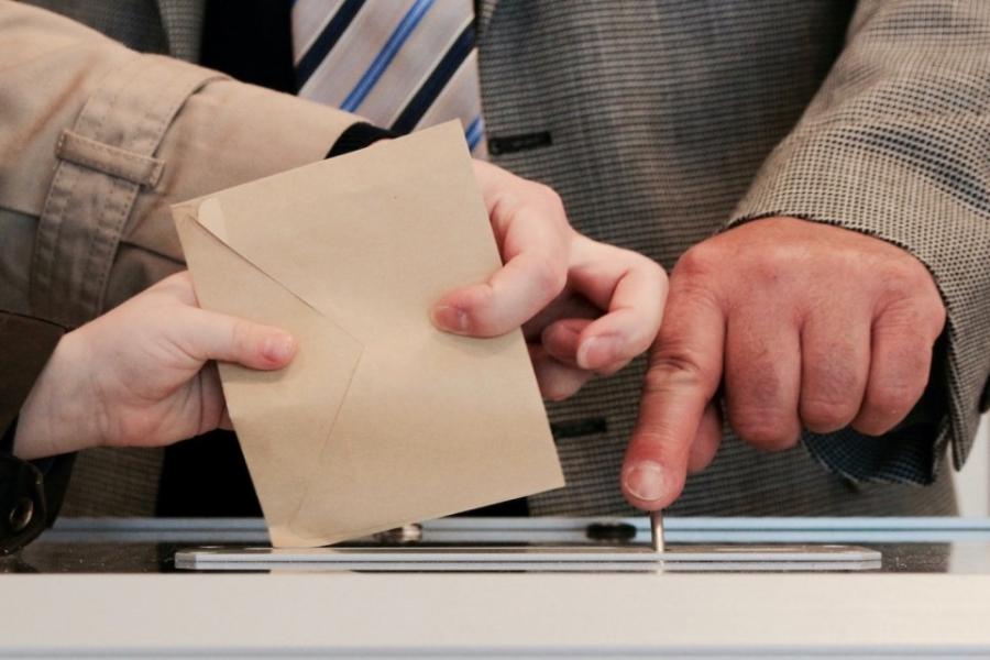 Hands handling a ballot