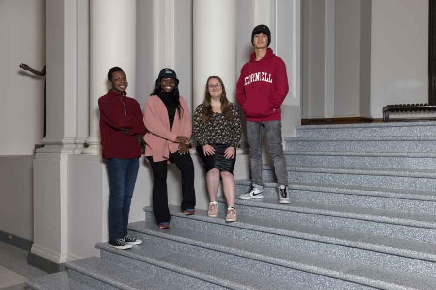 four students on stairs 