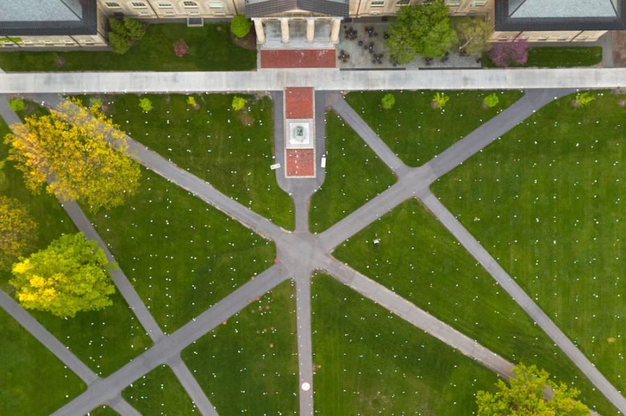 Aerial view of Cornell's Arts Quad, showing green lawn and grey paved paths